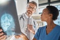 Brain, x ray and neurology doctors in a meeting working on a skull injury in emergency room in a hospital. Diversity Royalty Free Stock Photo