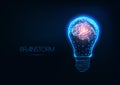 Brainstorm concept with futuristic glowing low polygonal light bulb and human brain Royalty Free Stock Photo