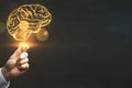 Brainstorm, creative idea and business success concept with digital glowing yellow human brain in man hand on abstract dark blank Royalty Free Stock Photo