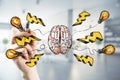 Brainstorm and thinking concept with man hand drawing sketch of human brain, lightning strike signs and light bulbs Royalty Free Stock Photo