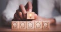 brainstorming creative idea and innovation. Hand putting over wooden cube block with light bulb icon on many people together