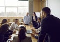 Group of business people in big office have meeting and discussing company stats and sheets. Royalty Free Stock Photo