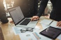 Brainstorming team of asian startup coworkers doing finance report on desk at home office. Royalty Free Stock Photo