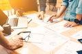 Brainstorming team of asian startup coworkers doing work on desk Royalty Free Stock Photo