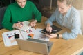 Brainstorming. Two young business women sitting at table and discussing business plan. Royalty Free Stock Photo