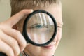 Brainy boy with magnifying glass