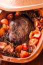 Braised beef in an earthenware casserole