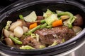 Braised beef pot roast stew with vegetables on table