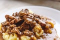 Braised beef, beef stroganoff with gravy on mashed potatoes. Close-up, top view