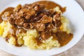 Braised beef, beef stroganoff with gravy on mashed potatoes. Close-up, top view