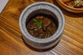 braised beef teriyaki in a traditional hotpot on a table in a restaurant