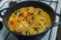 Braised eggplant with meat and rice in Israeli spices in a cast-iron high frying pan on the stove.