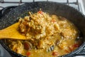 Braised eggplants with meat and rice in spices with dogwood in an Israeli style in a cast-iron high frying pan with a