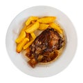 Braised pork knuckle served with garnish of crispy french fries