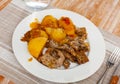 Braised rabbit served with potato garnish