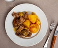 Braised rabbit served with potato garnish Royalty Free Stock Photo