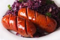 Braised red cabbage and grilled sausages closeup. horizontal Royalty Free Stock Photo