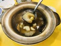 Braised Sea Cucumber in brown soup served in clay pot. Royalty Free Stock Photo