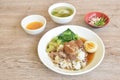 Braised  slice pork leg stew black Chinese herb soup topping brown boiled egg half cutting eat couple pickled cabbage and kale Royalty Free Stock Photo