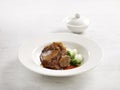 Braised US Angus Beef Short Rib in Brown Sauce served in a plate side view on grey marble background USA Food Royalty Free Stock Photo