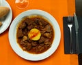 Braised veal with baked potato and mushrooms