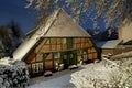 The historic fisher house in Brake Unterweser, Germany during a scenic snowy winter night