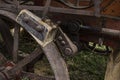 Brake of a historic agricultural vehicle, a threshing machine consisting of a wooden brake pad, steel wheel and steel actuating