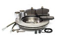 Brake parts on white: brake pads, disc, brake hose, guides, cylinders