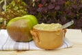 Bramley apple and a pot of apple sauce.