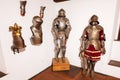 Bran, Brasov, Romania- June, 2023: A collection of medieval knight armors exhibited in historical museum setting with wall-mounted