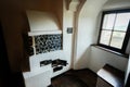 Bran, Brasov, Romania- June, 2023: Cozy interior view showcasing a traditional European tiled stove next to a window with