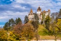 Bran castle in Romania aka the castle of Dracula from Transylvania in autumn colors against dramatic sky Royalty Free Stock Photo