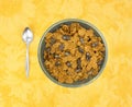 Bran flake cereal with raisins in a stoneware bowl Royalty Free Stock Photo