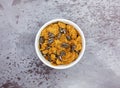 Bran flake cereal with raisins in a white bowl Royalty Free Stock Photo