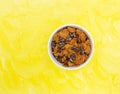 Bran flake cereal with raisins in a white bowl Royalty Free Stock Photo