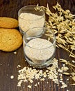 Bran and flour oat in glass with cookies on board