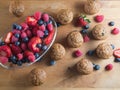 Bran muffins and berry fruit on wooden board Royalty Free Stock Photo