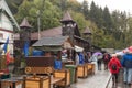 Visitors in a rainy day walk towards Bran Castle in Bran city inVisitors in a rainy day walk towards Bran Castle in Bran city in R