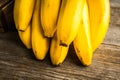 Branch of bananas on the rustic background Royalty Free Stock Photo