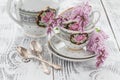 Branch blooming lilac and coffee Cup with milk on a wooden table Royalty Free Stock Photo