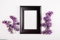 Branch of bright lilac flowers on the white background. Minimal spring concept. Congratulations on mother`s day. Flat lay with