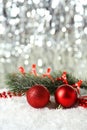 Branch of Christmas tree with balls on snow, close up Royalty Free Stock Photo