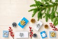 A branch of a Christmas tree, blue and white gift boxes, cones and red berries. Christmas composition with a copy space Royalty Free Stock Photo