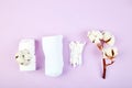 Branch of cotton plant, eared sticks, cotton pads, towel, cosmetic makeup removers tampons, hygienic sanitary swabs on purple Royalty Free Stock Photo