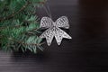Spruce branch decorated with a bow on a black background Royalty Free Stock Photo