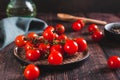 Branch of fresh ripe cherry tomatoes on a plate on the table Royalty Free Stock Photo