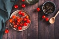 Branch of fresh ripe cherry tomatoes on a plate on the table top view Royalty Free Stock Photo