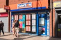 Branch front and entrance to Dawson and Sanderson Travel Agent store shop showing sign, signage, logo, branding with window displa Royalty Free Stock Photo