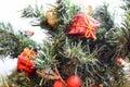 A branch of a green New Year tree decorated with red, small gifts, toys, golden leaves and balls. Royalty Free Stock Photo