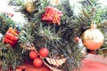 A branch of a green New Year tree decorated with red, small gifts, toys, golden leaves and balls Royalty Free Stock Photo